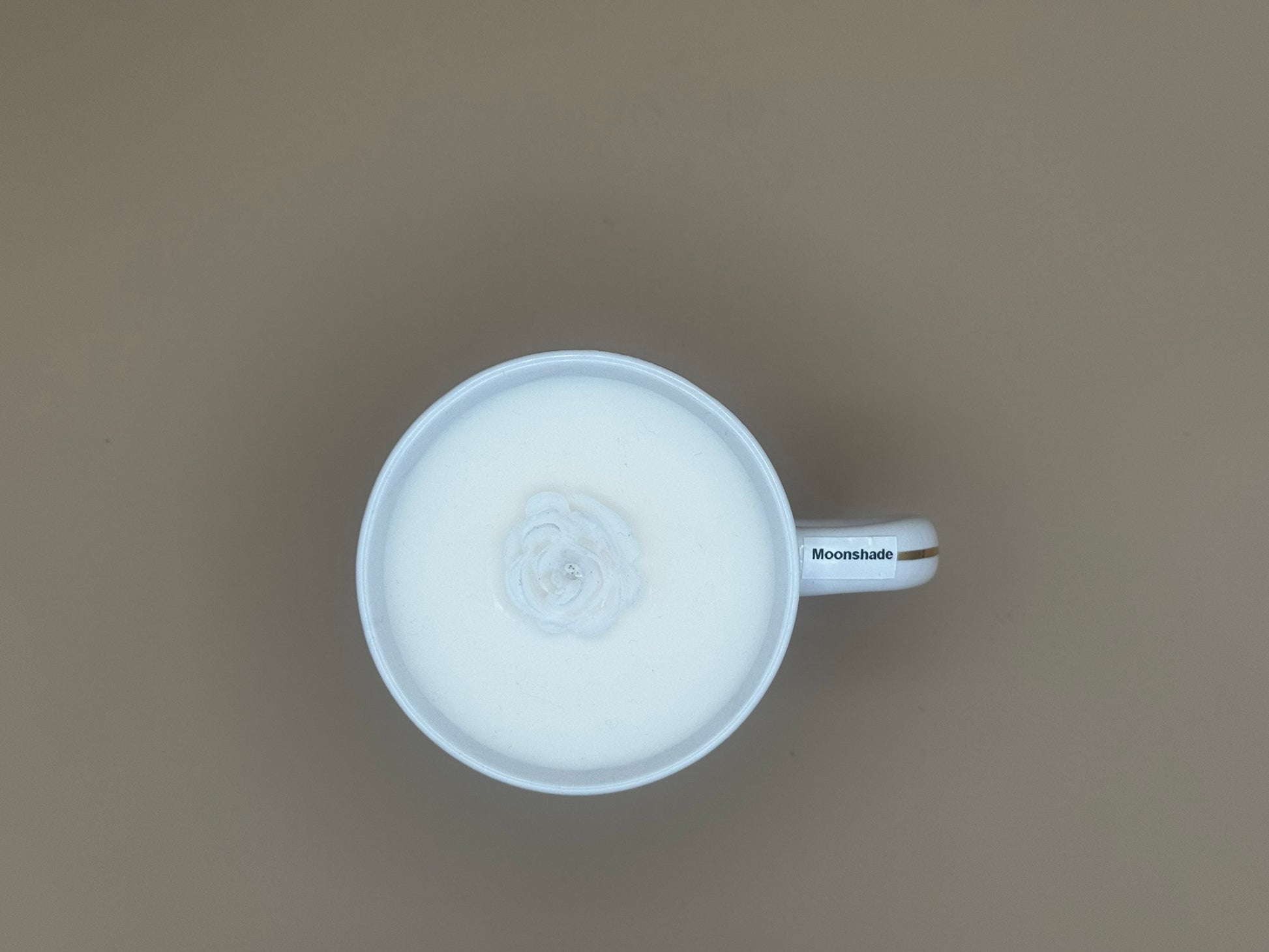White mug with a handle on a brown background