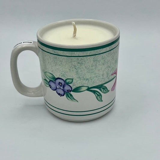 Ceramic mug with a candle inside on a white background